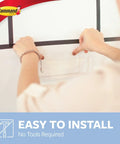 Person installing Large Caddy Organizer With Four Strips For Under Sink And Kitchen Cabinets Holds Up To Four Pounds Damage Free