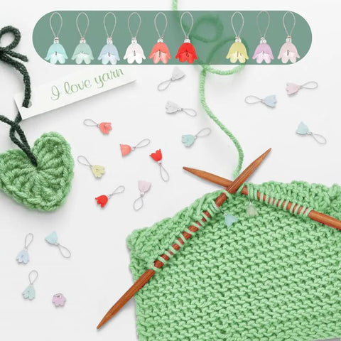 Flower Stitch Markers Set Of 18 In 9 Colors For Knitting Crochet And Weaving With Acrylic Markers And Stainless Steel Wire shown on green yarn