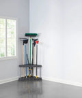 Corner Garage Tool Tower Rack That Holds 30 Long Handled Tools Rakes Brooms Shovels Easy to Assemble Space Saving Wall Mount Storage for Home Shed Shop Backyard in corner of a room with tools.