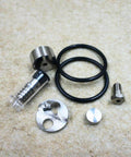 Waterjet check valve repair kit, six-piece metal components with black O-rings and fittings.
