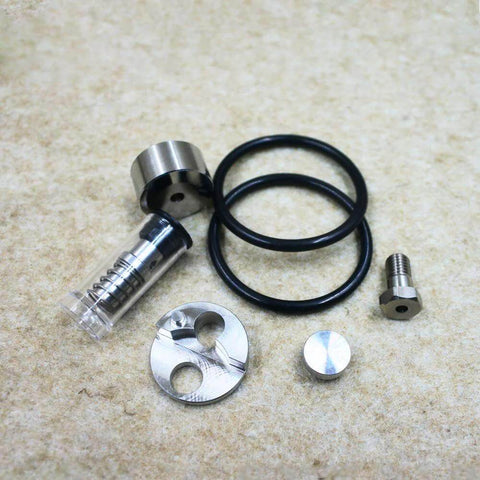 Waterjet check valve repair kit, six-piece metal components with black O-rings and fittings.