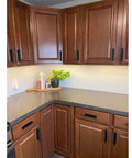 Modern kitchen with brown cabinets fitted with 16 Pack Self Stick Push Pull Helper ABS Plastic Wardrobe Handle For Cabinets And Drawers.