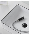 Close-up of USZWBY Vessel Sinks Small Apartment Bathroom Balcony Ceramic Wash Basin with black edge and faucet hose.