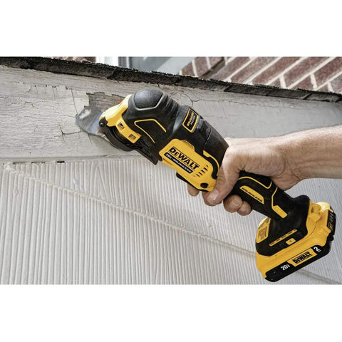 Atomic 20V Max Cordless Oscillating Tool Bare Tool With Brushless Motor cutting wood, handheld showing dual grip in use
