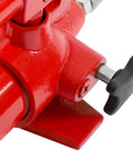 Close-up of red hydraulic porta power jack body with black adjustment knob and steel shaft.
