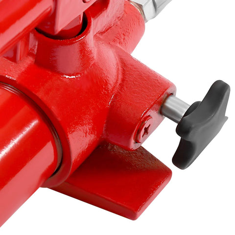 Close-up of red hydraulic porta power jack body with black adjustment knob and steel shaft.