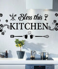Bless This Kitchen Wall Decor Sticker With Flower Art Removable DIY Vinyl Decal For Dining Room Kitchen Bar Restaurant Home Decor Cute Kitchen Quote Wall Sign For Cozy Vibes on white wall above counter with kitchenware.
