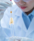 Scientist using 4 Piece Lab Flask Brush Set for 250ml volumetric flasks, glass tubes and beakers cleaning brushes in lab.