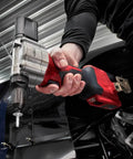 High-Torque M12 Cordless Rivet Gun Bare Tool built to rip through stainless steel rivets, held in hand for installation.