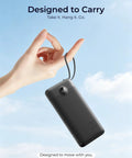 Hand holding the Total Game Changer Portable Charger With Four Built In Cables And Massive Twenty Thousand Mah Fast Charging Power Bank, ideal for travel.