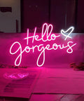 Hello Gorgeous Pink LED Neon Sign For Wall Decor, 21 inch neon light glowing on a wall background for parties.