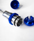 Close-up of Blue Aluminum BigBore Shocks for 4x4 and 2WD Trucks, showing disassembled parts and spring detail.