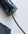 Close-up of flexible and leak-resistant heavy duty high temperature steam hose for steam irons with durable tubing attached to iron.