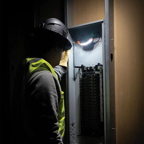 Worker with Rechargeable LED Wide Beam Headlamp With Hard Hat Mounts For Work, 770 Lumens, inspecting electrical panel.