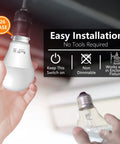 Man installing Dusk To Dawn LED Sensor Light Bulbs 4 Pack A19, UL Listed, Automatic On Off in E26 base