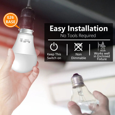 Man installing Dusk To Dawn LED Sensor Light Bulbs 4 Pack A19, UL Listed, Automatic On Off in E26 base