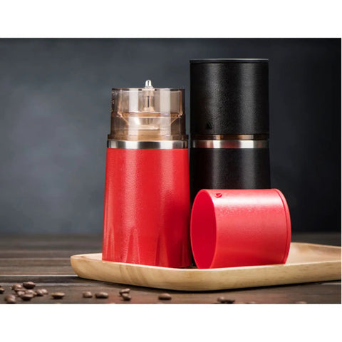 Kickstart Your Morning Anywhere With This Portable Manual Coffee Maker Equipped With Integrated Grinder And Bean Compartment Ideal For Camping Runs And Highway Hauls Pull Smooth Rich Brews Straight To Mug Effortless. Red and black manual coffee maker with grinder on a wooden tray.