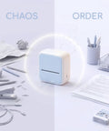 Vestamore Portable Inkless Thermal Label Maker Machine With Wireless Mobile Printing For iOS And Android in light blue color, surrounded by office supplies.