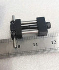 Badass Strength Precision Vise Stop Locators For CNC Milling Machines, 25.4 mm wide steel tool on a ruler for scale.