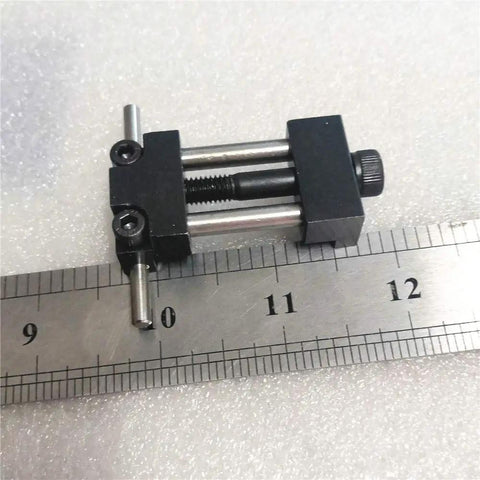 Badass Strength Precision Vise Stop Locators For CNC Milling Machines, 25.4 mm wide steel tool on a ruler for scale.