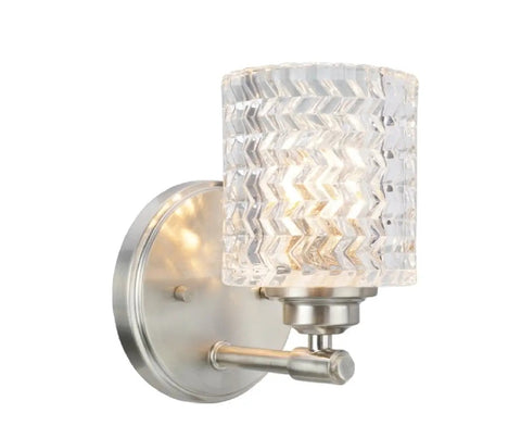 Side view of a brushed nickel sconce with clear patterned glass shade from a Four Light Metal Bathroom Vanity Wall Light Fixture In Brushed Nickel With Clear Glass Shades 31 And A Half Inches Wide Sleek Modern Transitional Style UL Listed For Bathroom Use Over Mirror And Vanity Requires Four 60 Watt Max Bulbs.