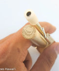 Hand holding Durable Brass Portable Tar Trap With Longer Stem And Mega Storage Pod Easy Open Closeable Lid Made In Hawaii