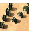 U-groove track wheel caster set, green with metal mounting brackets; multiple pieces