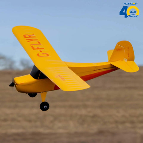 Champ Anniversary Edition 515mm RC Trainer Airplane BNF Basic With Safe Select Ready to Fly in flight over grass field