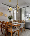 4 Light Lantern Chandelier In Black And Gold With A Dope Mid Century Geometric Square Cage Pendant Light above dining table