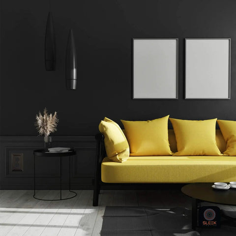 Modern living room with a yellow sofa against a dark wall featuring Pack Of Four Classic Black Wall Plate Covers For Outlets And Switches In One Gang Duplex Style With Rocker Receptacle Toggle And Combo Options Durable Build And Easy Installation For Home And Office.