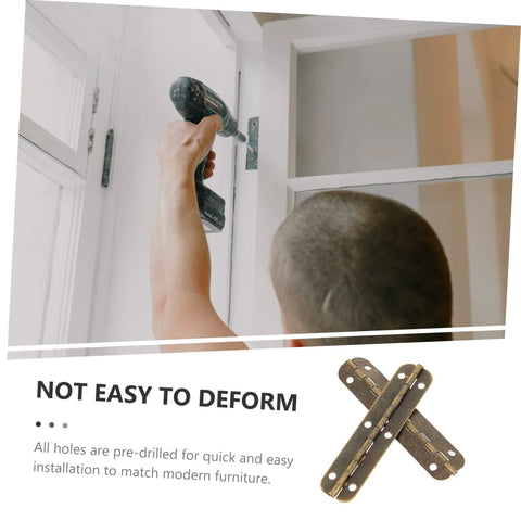 Brass piano hinge being installed on a white cabinet door by hand with a drill
