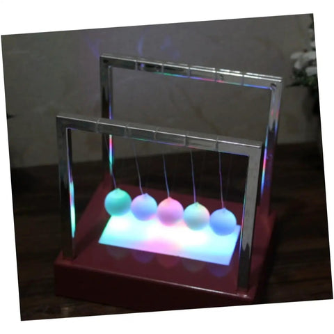 Red glowing pendulum desk decor Newton's cradle ornament for home office demonstrates physics energy conservation battery operated fun requires 4 AA batteries not included