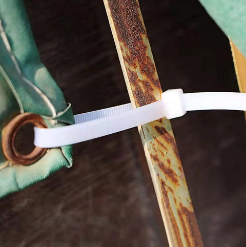 Beefy 24 Inch Zip Ties securing outdoor fabric to rusted metal pole, Heavy Duty Cable Ties for Outdoor Use, Extra Long 600mm Industrial Grade