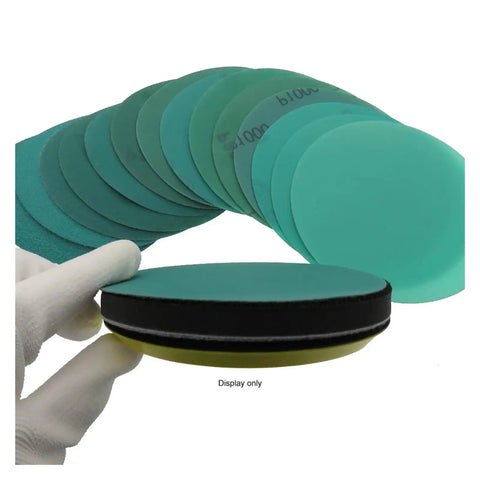 Rock Solid 30 Pc Set Of 5 Inch Hook And Loop Sanding Discs With Green Abrasive Film For Orbital Sanders, showing stacked discs and hand.