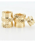 Close-up of knurled brass inserts from Hot Melt Brass Insert Nuts Kit For 3D Printing And Electronics 50 Pcs M2 M2.5 M3 M4 M5 M6