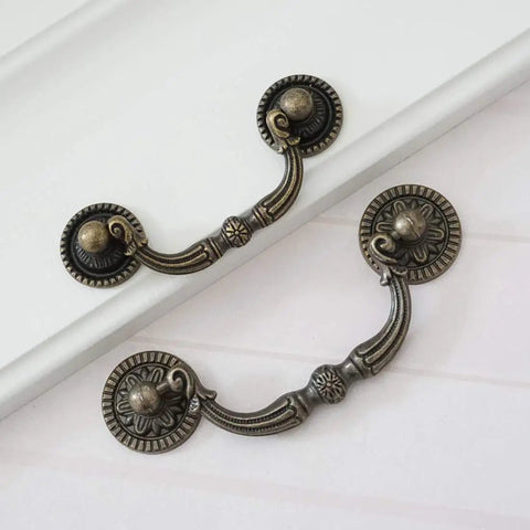 Knockout Antique Bronze Drop Bail Dresser Pull With 3 Inch Hole Centers Rustic Cabinet Handle, showing two detailed designs for heavy duty use.