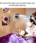 5X LED Magnifying Floor Lamp On A Rolling Stand For Salon Beauty Skincare Tattoo And Manicure Workstations in use by stylist