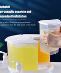 Five Point Five Liter Rotating Beverage Dispenser With Four Separate Compartments And Dripless Spigot showing clear liquid and slices of lime.