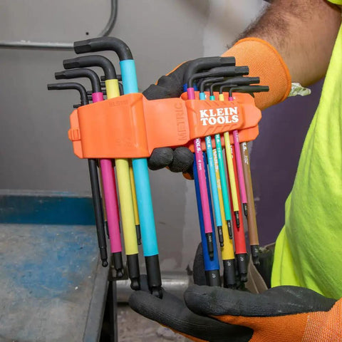 Color Coded Hex Key Wrench Set With Long Arm L Style And Ball End SAE And Metric 18 Piece Kit From One Sixteenth Inch to Three Eighth Inch And One Point Five To Ten Millimeters Beefy Heat Treated For Durability held by a person wearing gloves.
