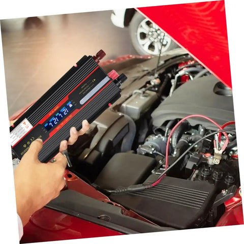 Straight Up Heavy Duty Dc To Ac Power Inverter Converter With Digital Lcd Screen And Rugged Aluminum Shell For Cars And Homes US Plug Adapter in hand over a car engine.