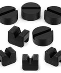 Eight black rubber jack stand pads in two styles: round slotted discs and textured rectangular blocks.