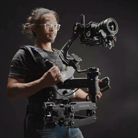 Operator using Thanos Pro Gimbal Vest Stabilizer System With Adapter Arm For All Day Filming, Shifts Heavy Gimbal Weight From Hands To Waist