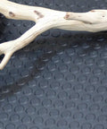 Coin Pattern Rubber Flooring 3.5mm Thick 36 Inch By 10 Foot Sheet Dark Gray with wood branch on anti-slip surface