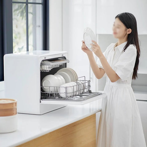 Portable Countertop Dishwasher Fully Automatic Compact Kitchen Essential With Intelligent Air Dry and Spacious Rollout Basket For Tiny Homes Ditch The Sink Grime Quick Cleanup Perfection with a user loading plates.