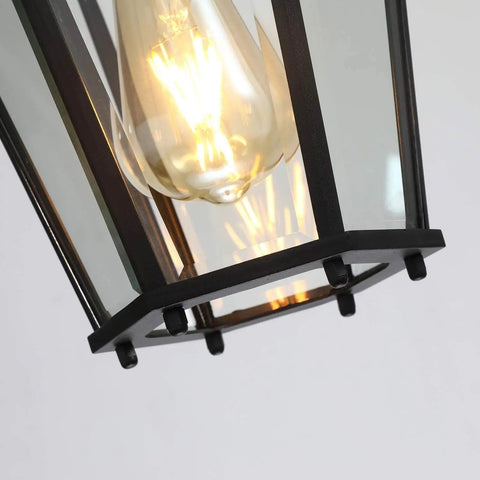 Close-up of black hanging lantern showing bulb inside from Outdoor Pendant Lights For Porch Black Hanging Lanterns With Adjustable Chain Create A Lit Weatherproof Aluminum Fixture Clear Glass Shade Rust Resistant Exterior Ceiling Light For Front Door Entryway