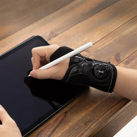 Boa Micro Adjustable Wrist Brace With Dial Fit System For Carpal Tunnel Tendonitis Arthritis And Wrist Pain Right Hand Medium Durable Microfiber Support No Velcro All Day Comfort Sit Tight Fit being used to write on a tablet