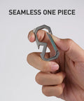 Badass Titanium Keychain Carabiner Multitool With Bottle Opener, shown in hand, seamless one-piece design, titanium alloy.