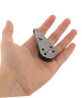 Hand holding a single stainless steel sailing pulley block from the Stainless Steel Sailing Pulley Block Set Four Pack With Bearing Wheels.