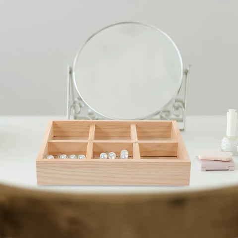 Slick Pine Wood Jewelry Organizer Tray With Six Compartments showing rings and pearls, placed on a vanity surface