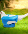 Durable Plastic Pigeon Holder For Feeding And Meds securing a pigeon in green grass setting